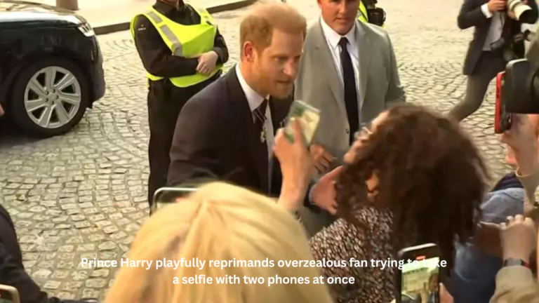 Prince Harry playfully reprimands overzealous fan trying to take a selfie with two phones at once